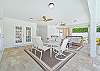 The oversized covered lanai offers a dining and seating area