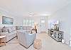 The beach style living offers comfortable seating and a large smart TV