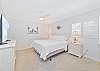 A king size bed and smart TV in the guest suite