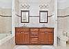 The en-suite primary bathroom features double sinks, a soaking tub (not jetted), and a large walk-in shower