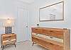 A king size bed and smart TV and walk-in closet with hanging space in the primary bedroom