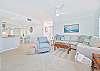 The beach style living offers comfortable seating and a large smart TV