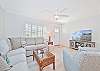 The beach style living offers comfortable seating and a large smart TV