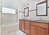 The en-suite primary bathroom features double sinks, a soaking tub (not jetted), and a large walk-in shower