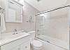 A shower-tub combo in the third bedroom