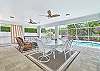The oversized covered lanai offers a dining and seating area