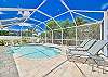 Plenty of lounge chairs and seating around the private landscaped heated pool. 
