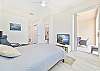 A queen size bed and Tv with cable in the primary bedroom