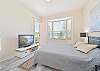 A queen size bed and Tv with cable in the primary bedroom