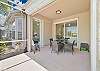 The oversized screened in lanai and patio overlooks Arrowhead golf course and lake