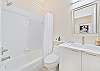 A shower-tub combo in the guest bathroom