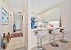 Fully equipped kitchen with bar seating and ding area