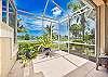 The oversized screened in lanai and patio overlooks Arrowhead golf course and lake