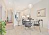 Fully equipped kitchen with bar seating and ding area