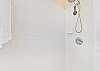 The en-suite primary bathroom is equipped with a shower