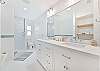 Dual sinks, a shower and separate tub in the upstairs primary bathroom