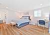 A king size bed, office nook and smart TV  in the upstairs primary bedroom