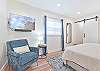 The first guest bedroom (downstairs) has the cabana bathroom en-suite, and is equipped with a king bed and smart TV