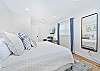 The first guest bedroom (downstairs) has the cabana bathroom en-suite, and is equipped with a king bed and smart TV