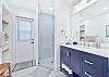 The en-suite cabana bathroom has a shower and large countertop