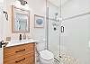 The guest bathroom is equipped with a spacious walk-in shower
