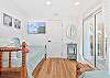Two twin beds and a smart TV in the third bedroom. Sliding doors provide access to the balcony
