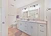 En-suite primary bathroom with double sinks and spacious walk-in shower