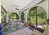 The screened corner patio with private landscaping allows a nice breeze. 