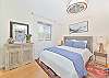 A queen size bed in the guest suite 
