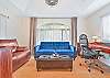 The bonus room off the primary suite offers seating and an office nook