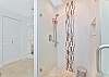 En-suite primary bathroom with double sinks and spacious walk-in shower