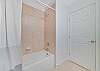 A shower-tub combo in the guest bathroom