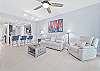Reclining sofa end seats & chair and large smart TV in the living. Sliding doors provide access to the screened in lanai