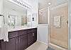 Dual sinks and spacious shower in the en-suite primary bathroom