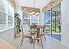 Dining off the kitchen offers lanai access 