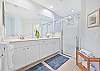 Dual sinks and a spacious shower in the en-suite primary bathroom