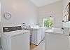 Laundry room with two washers and dryers on the first floor with an assigned unit schedule as well as open times.