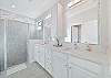 The en-suite primary bathroom features dual sinks and a spacious walk in shower