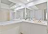 The ensuite primary bathroom features dual sinks and a shower