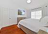 A king size bed and smart TV in the primary bedroom