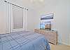 The guest bedroom is equipped with a queen size bed and smart TV
