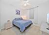 The guest bedroom is equipped with a queen size bed and smart TV