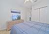 The guest bedroom is equipped with a queen size bed and smart TV