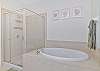 The en-suite primary bathroom features a soaking tub and shower