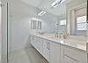 Dual sinks and a spacious walk-in shower in the en-suite primary bathroom