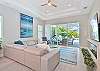 Living with fireplace, TV and sliding door opening up to the pool area