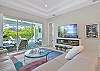 Living with fireplace, TV and sliding door opening up to the pool area