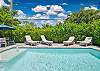 Private heated pool with lounge chairs to soak up the sun