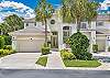 First floor coach home in the exclusive West Bay Club community. Two car attached garage