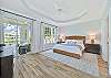 The primary bedroom with a king size bed offers peaceful lake view